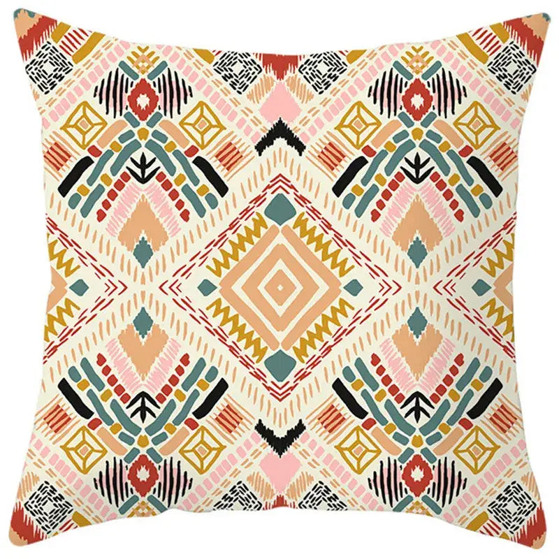 A square throw pillow cover with a vibrant ethnic bohemian geometric pattern in pink orange teal black and cream decorbites