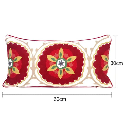 Rectangular pillow cover with embroidered floral red and cream ethnic tassels featuring a starburst design and scalloped edges