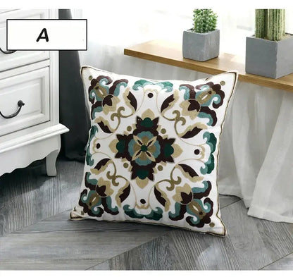 White square ethnic style canvas pillow cover with intricate teal brown and gold floral embroidery for living room decor