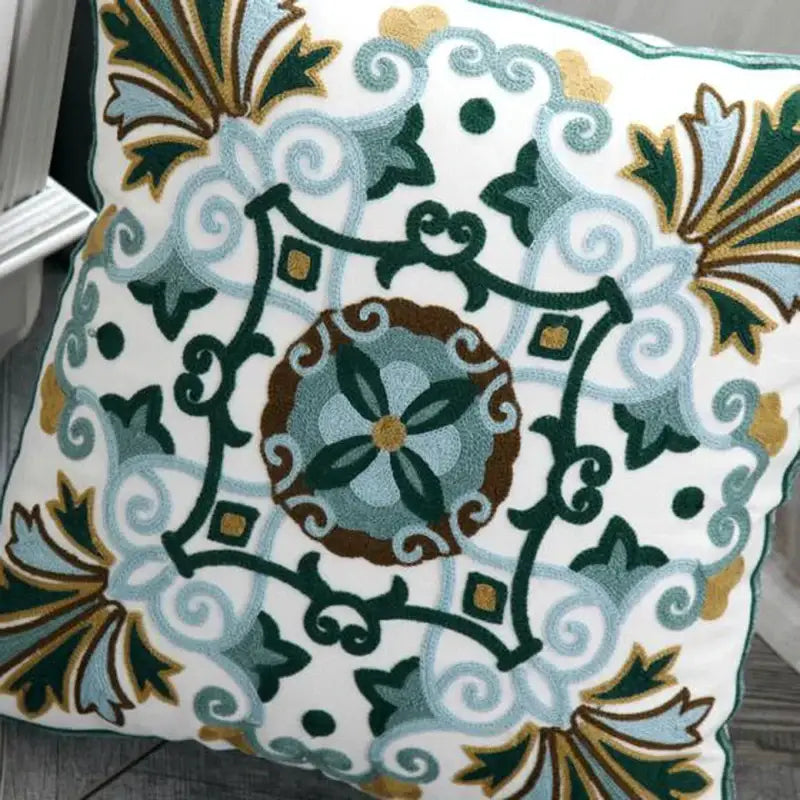 White cushion pillow cover with ethnic style canvas floral embroidery in green blue brown and gold for living room decorbites decor