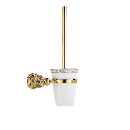 Gold-finished toilet brush holder with white ceramic cup featuring greek key pattern in decorbites crystal bathroom rack
