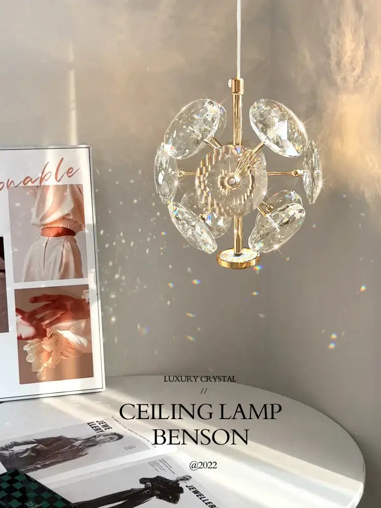 A gold-toned European mini pendant light with polished chrome and clear faceted crystal discs for dining room