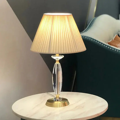 Elegant crystal floor lamp with gold-finished base and beige pleated fabric shade for living room decor