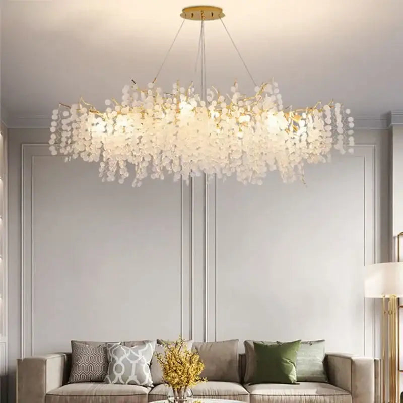 A modern european style gold tree branch chandelier with cascading white translucent glass beads for dining room decorbites gold tree