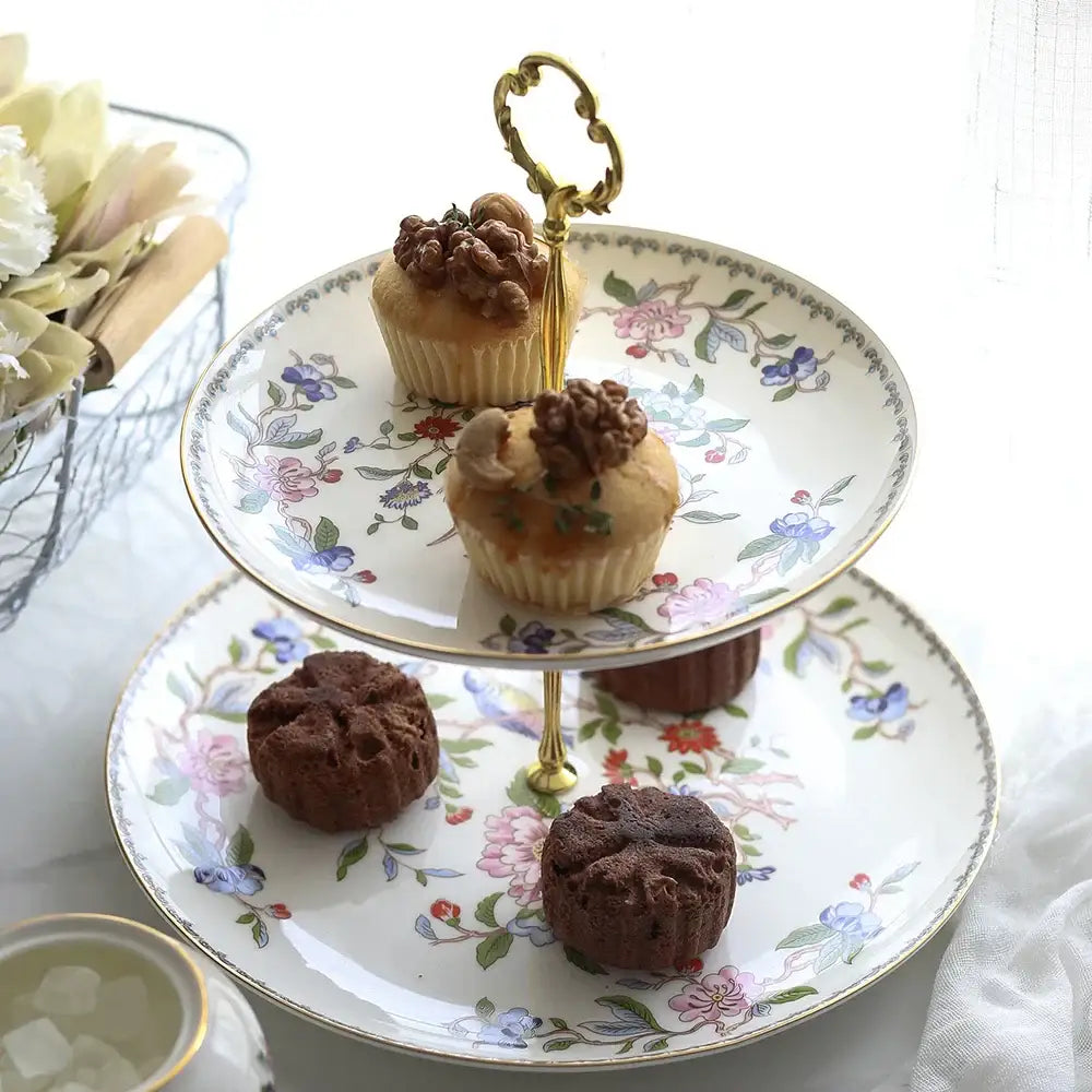 A delicate two-tiered porcelain dessert stand with floral patterns and gold trim from the exquisite set coffee set decorbites tea