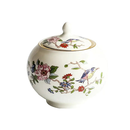 White ceramic sugar bowl with lid featuring colorful hand-painted birds and flowers in an exquisite coffee set decorbites tea