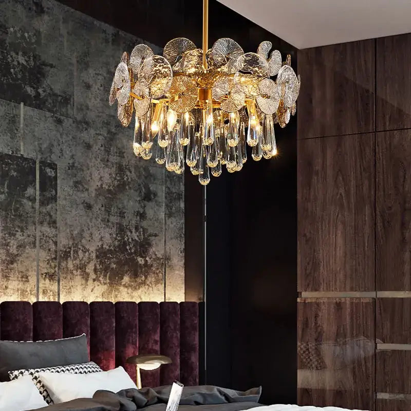 Exquisite piece crystal chandelier featuring gold-toned fan design with translucent glass petals and crystal teardrops for living rooms