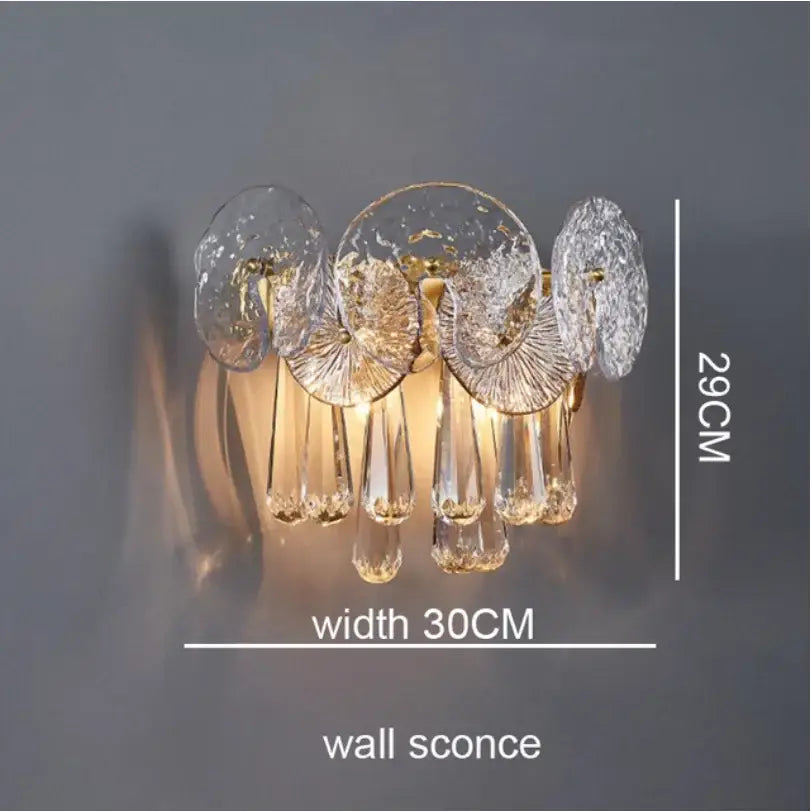 A modern crystal chandelier wall sconce with clear textured glass discs and gold-toned frame exquisite piece