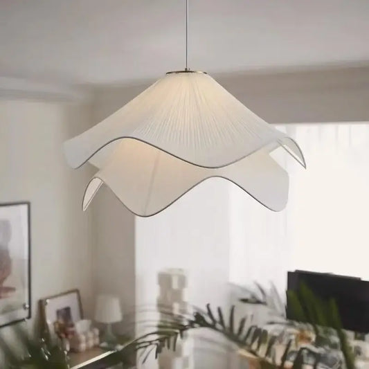 A white paper fabric petal pendant light with delicate petal design by decorbites for dining room decor