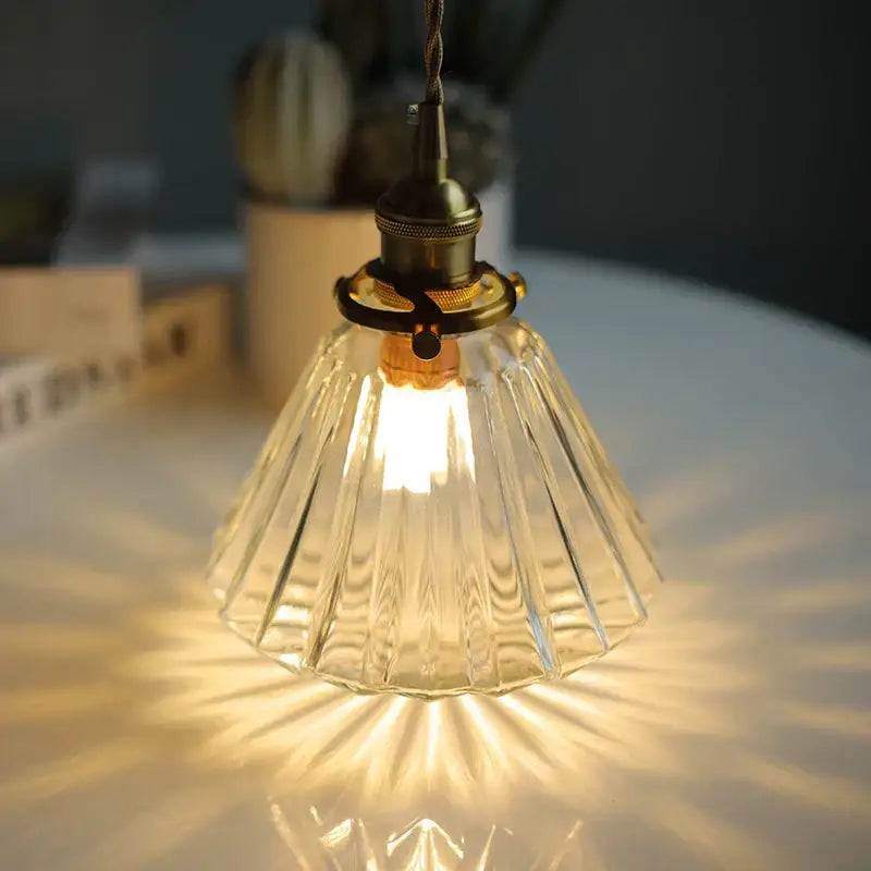 Faceted clear glass copper pendant lamp with warm tones and brass hardware for dining room decorbites clear glass lighting