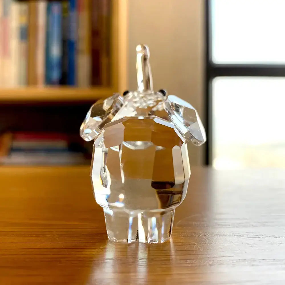 A faceted clear glass pig figurine with polished finish and black bead eyes for decorbites clear glass decor