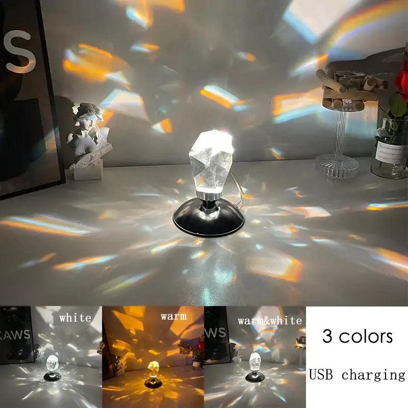 Faceted crystal diamond table lamp with black base projecting colorful rainbow patterns for bedroom lighting