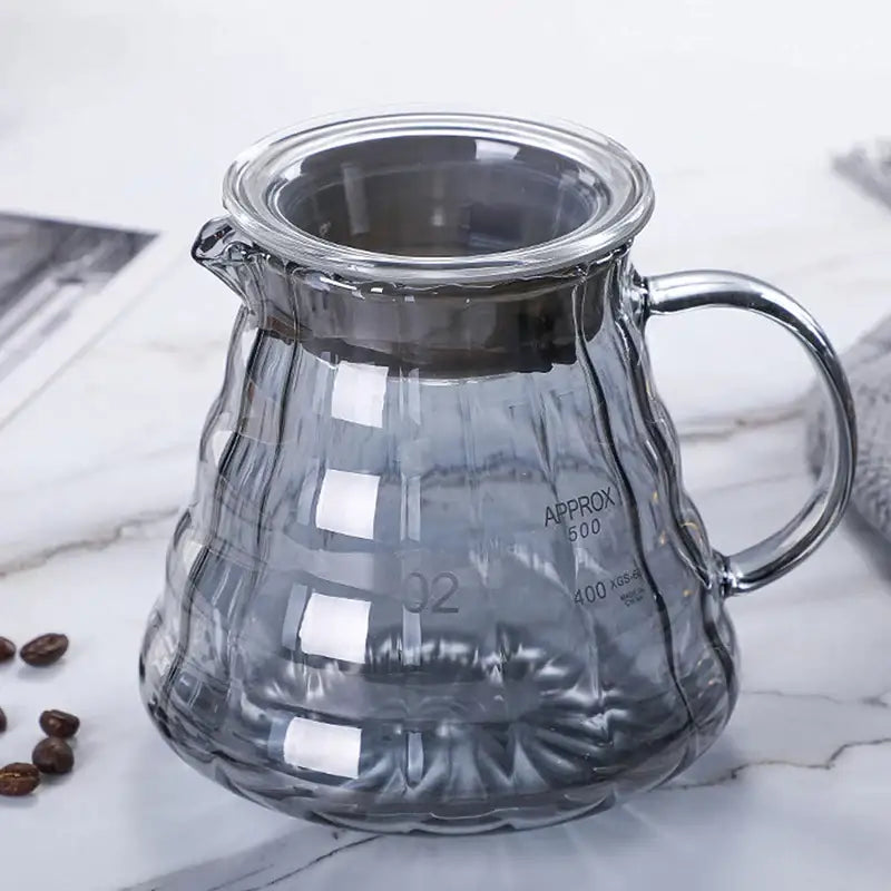 Clear glass coffee carafe with textured ribbed diamond glass design and silver-toned metal lid and filter cup