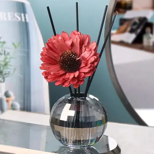 Faceted gold crystal ball aroma diffuser with a sparkling silver geometric base and coral-pink flower bedroom decor