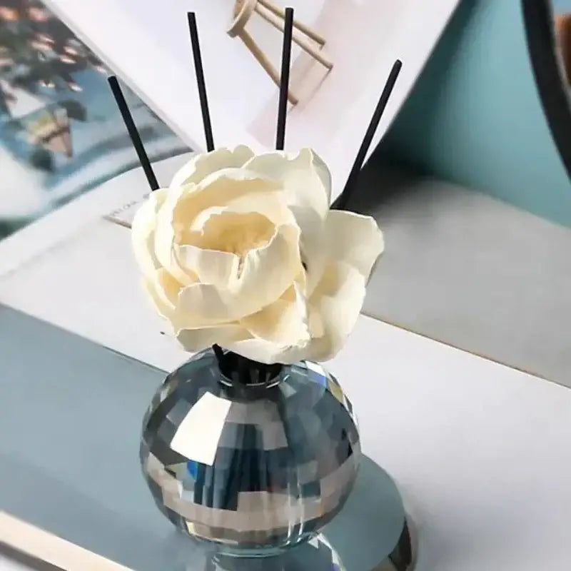 Faceted gold crystal ball aroma diffuser with geometric base glass diffuser cream rose and black reed sticks for bedroom decor