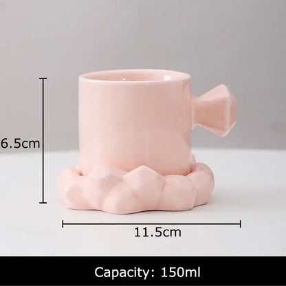 Pastel pink ceramic coffee mug with faceted handle and geometric base designed for 150ml in mug set decor