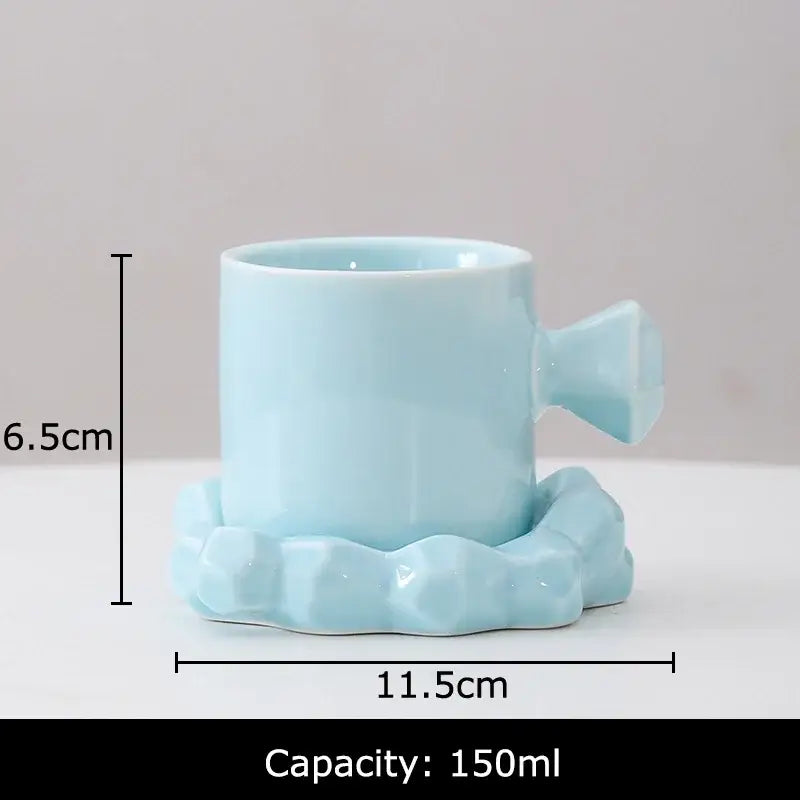 Faceted light blue porcelain coffee mug set with candy cane style handle and matching saucer for kitchen decor