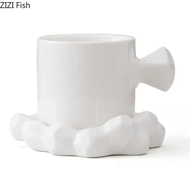 Faceted light blue porcelain coffee mug set featuring a white ceramic coffee mug with sculpted handle and cloud base by zizi fish