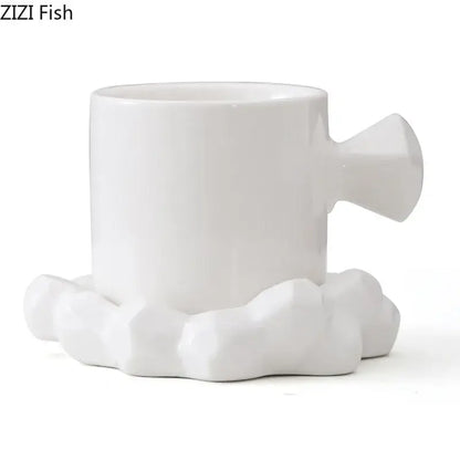 Faceted light blue porcelain coffee mug set featuring a white ceramic coffee mug with sculpted handle and cloud base by zizi fish