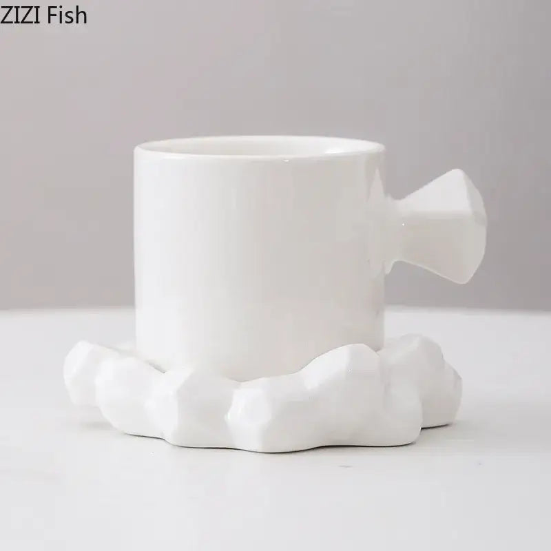 Faceted light blue porcelain coffee mug set featuring a white ceramic coffee mug with geometric handle and cloud base