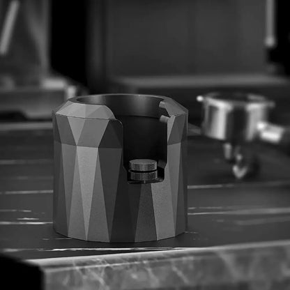 Faceted matte black metal espresso portafilter holder with geometric design and textured knob for espresso portafilter stand