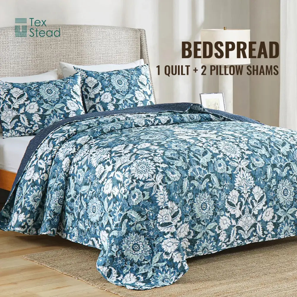 Farmhouse blue and white floral quilted bedding set with matching pillow shams featuring a textured design