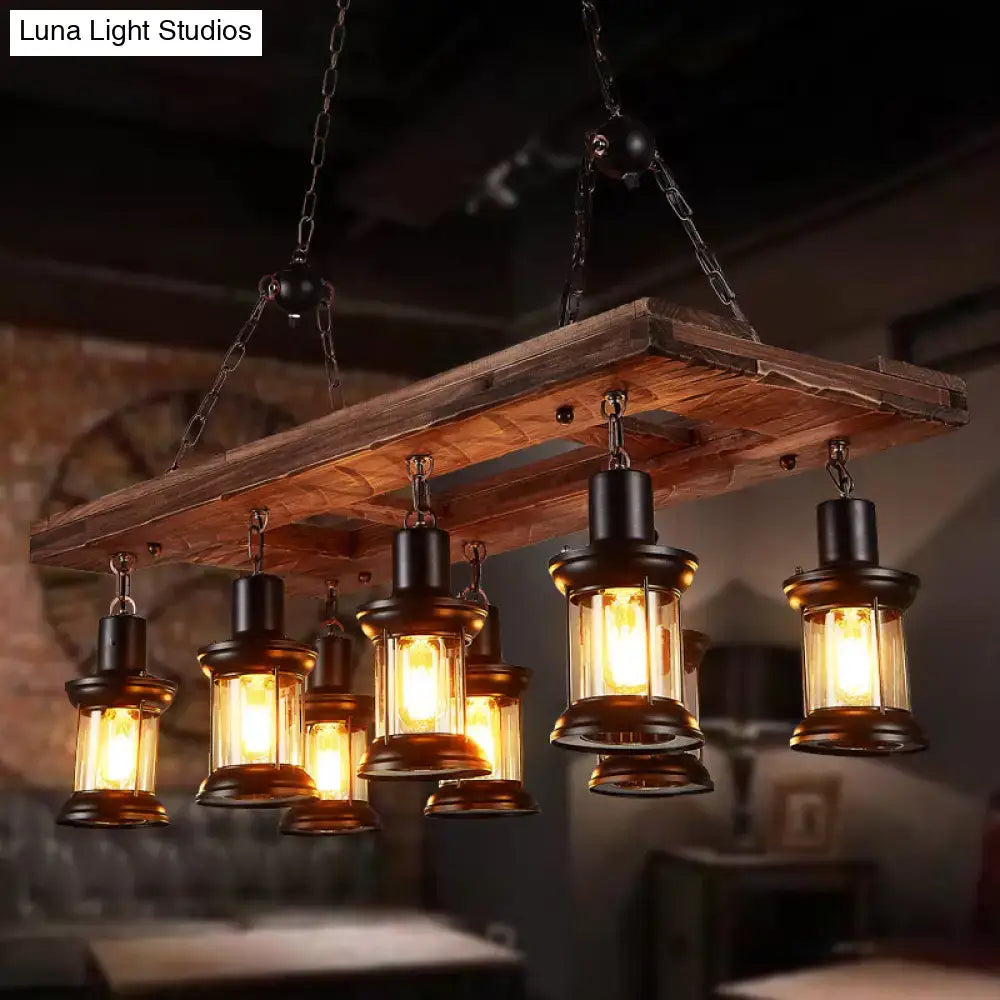Rustic wooden plank chandelier with farmhouse clear glass lanterns featuring black metal frames and warm amber shades