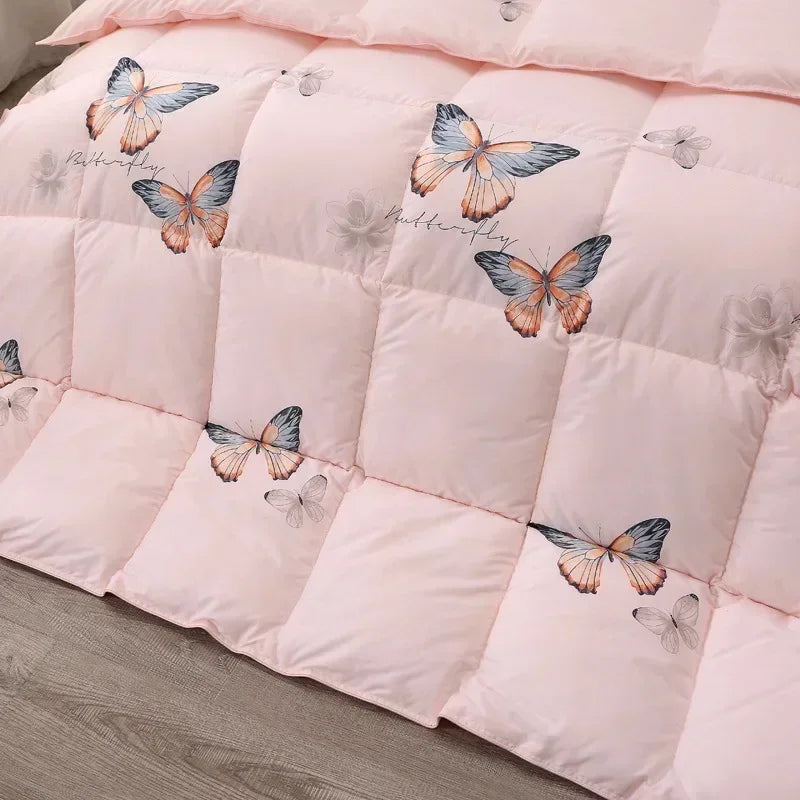 Pink quilted comforter with colorful butterfly pattern made of high-quality white goose down for winter bedding