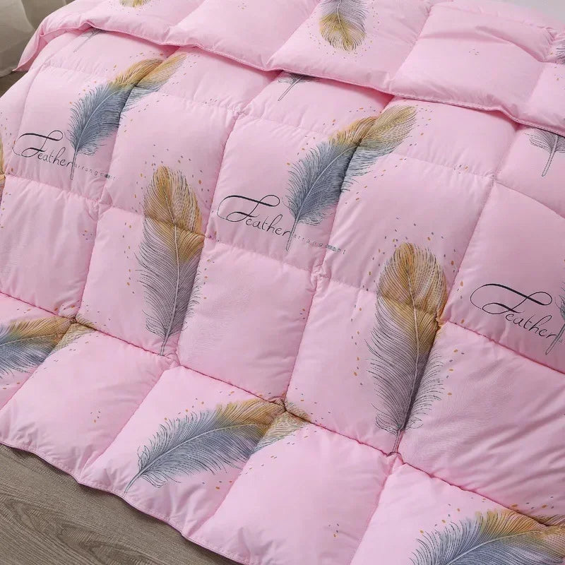 Pink quilted comforter with blue and gold feather pattern and feather embroidery made of white goose down for winter use
