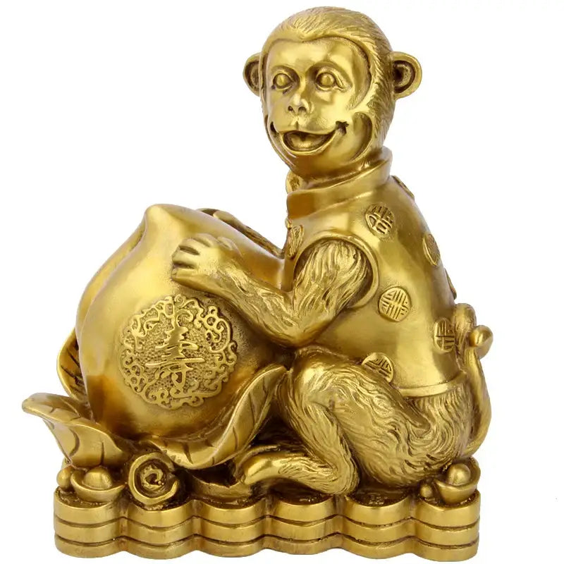 Golden brass copper monkey figurine in traditional chinese attire seated with decorative copper monkey cornucopia money bag