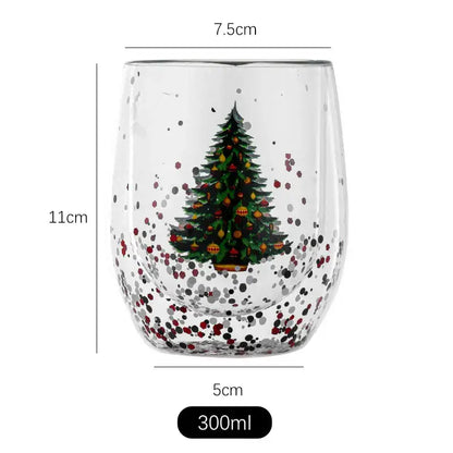 A clear double wall glass mug with a festive christmas tree design and colorful ornament accents for kitchen decor