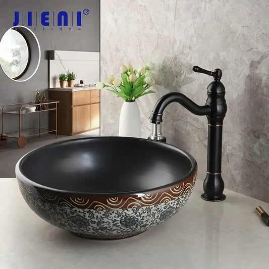 Black ceramics sink with intricate white and brown floral patterns and brass faucet in decorbites bathroom basin set