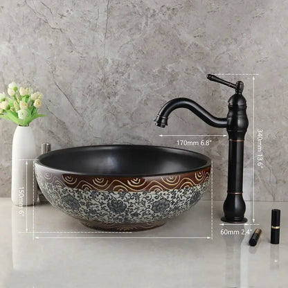 Floral black ceramics sink with intricate white floral patterns and brown accents paired with brass faucet decorbites black ceramics