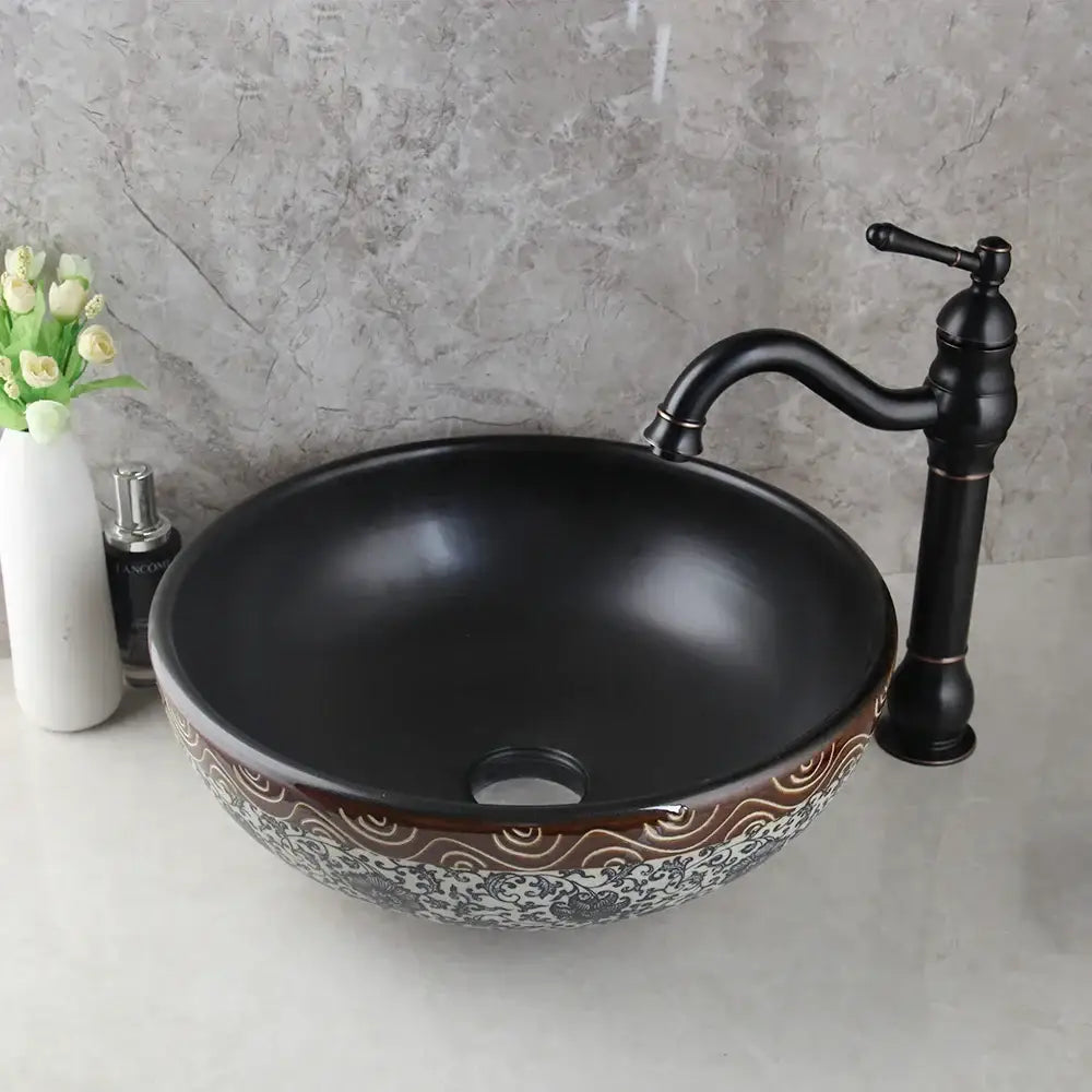 Black ceramics sink with intricate brown and white wave-patterned rim and brass faucet in decorbites bathroom basin set