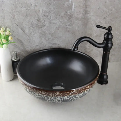 Black ceramics sink with intricate brown and white wave-patterned rim and brass faucet in decorbites bathroom basin set
