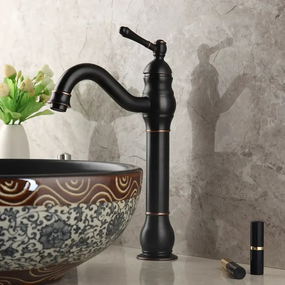Black matte brass faucet with copper accents and curved spout paired with decorbites black ceramics sink basin set