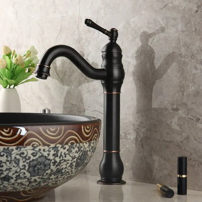 Black matte brass faucet with copper accents and curved spout paired with decorbites black ceramics sink basin set
