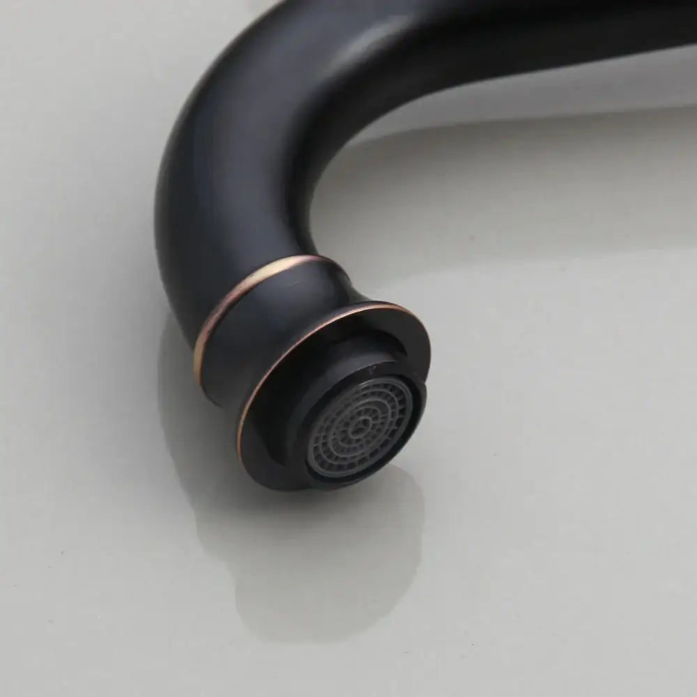 Black matte brass faucet with copper accent ring paired with decorbites black ceramics sink in bathroom basin set