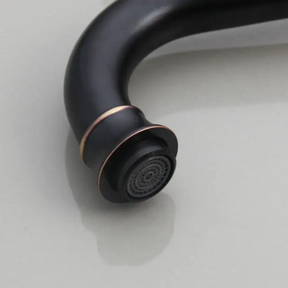 Black matte brass faucet with copper accent ring paired with decorbites black ceramics sink in bathroom basin set