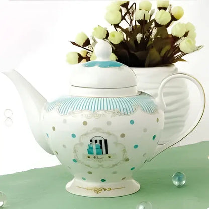 A delicate white porcelain bone china tea set teapot with turquoise polka dots and gold trimmed arched window design