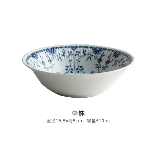 A white ceramic bowl with delicate blue floral patterns is part of a floral blue and white ceramic dining set