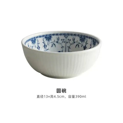 White ceramic bowl with blue floral rim and vertical ridges part of floral blue and white ceramic dining set