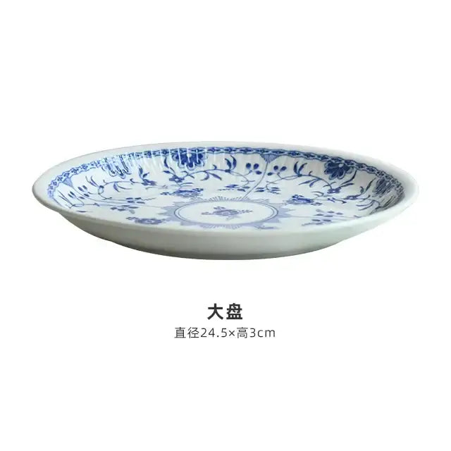 White ceramic plate with intricate blue floral and vine patterns from a floral blue and white ceramic dining set