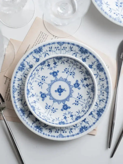 Floral blue and white ceramic dining set featuring intricate floral patterns for elegant dining room use