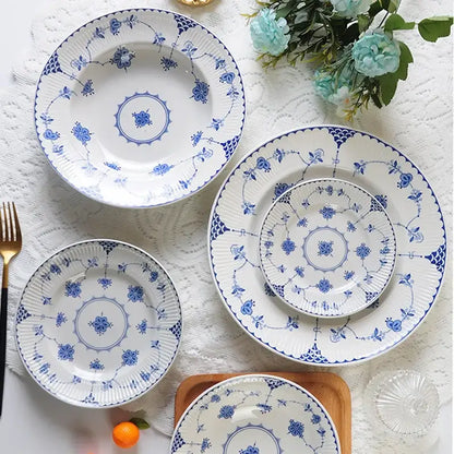 Set of four white porcelain dinner plates with blue floral and geometric patterns from decorbites ceramic dinnerware