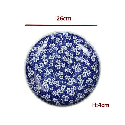 A round deep blue porcelain serving plate with white floral patterns and crackle texture for dining tableware