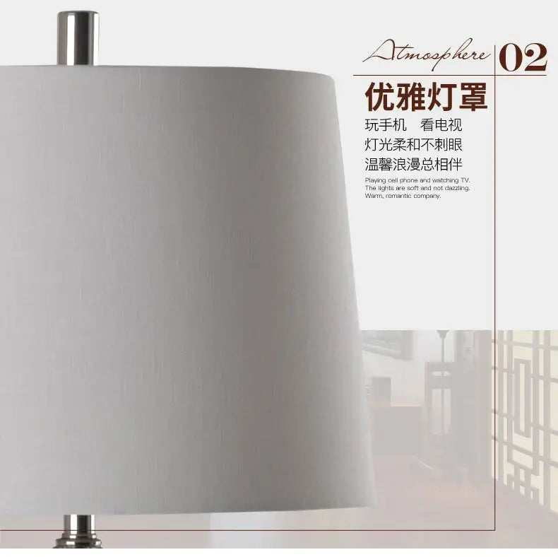 A sleek off-white fabric lampshade with metallic silver base on a decorbites blue white porcelain table lamp