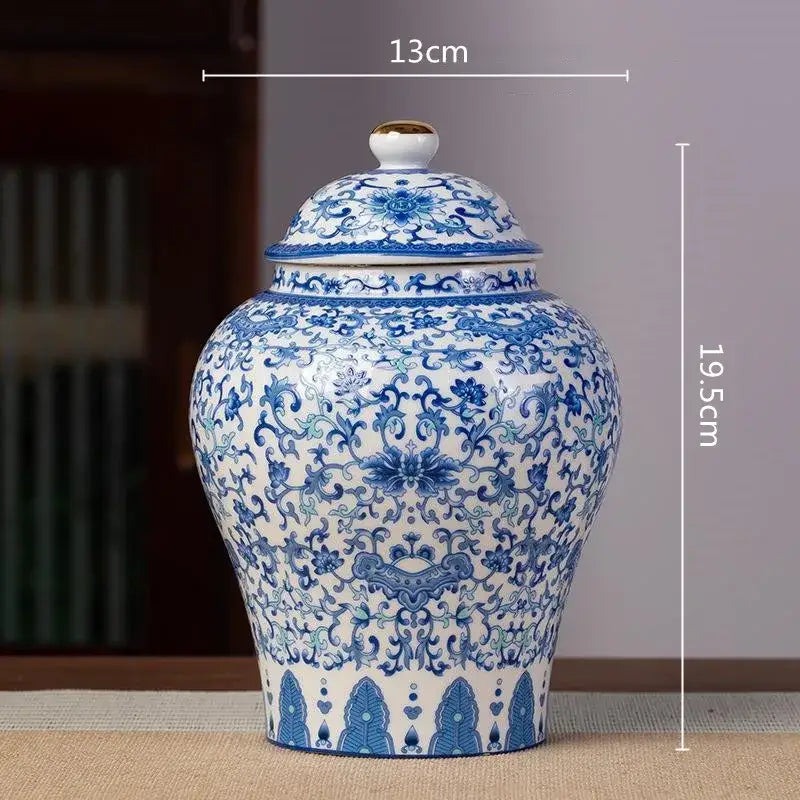 A classic blue and white porcelain tea pot storage container with intricate floral patterns and a gold-accented lid