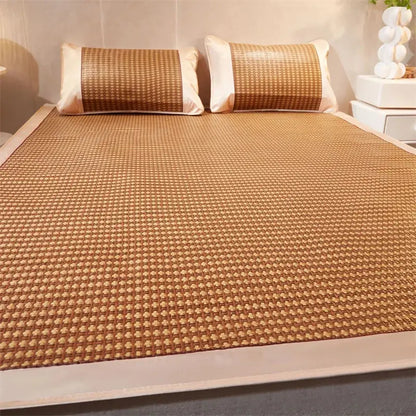Tan woven bamboo cooling rattan mat with subtle grid pattern and matching pillowcases for bedroom use