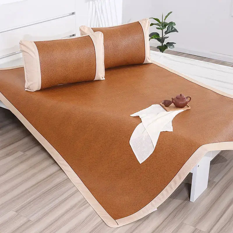 Brown woven bamboo cooling rattan mat mattress pad with cream fabric trim for bedroom bed use